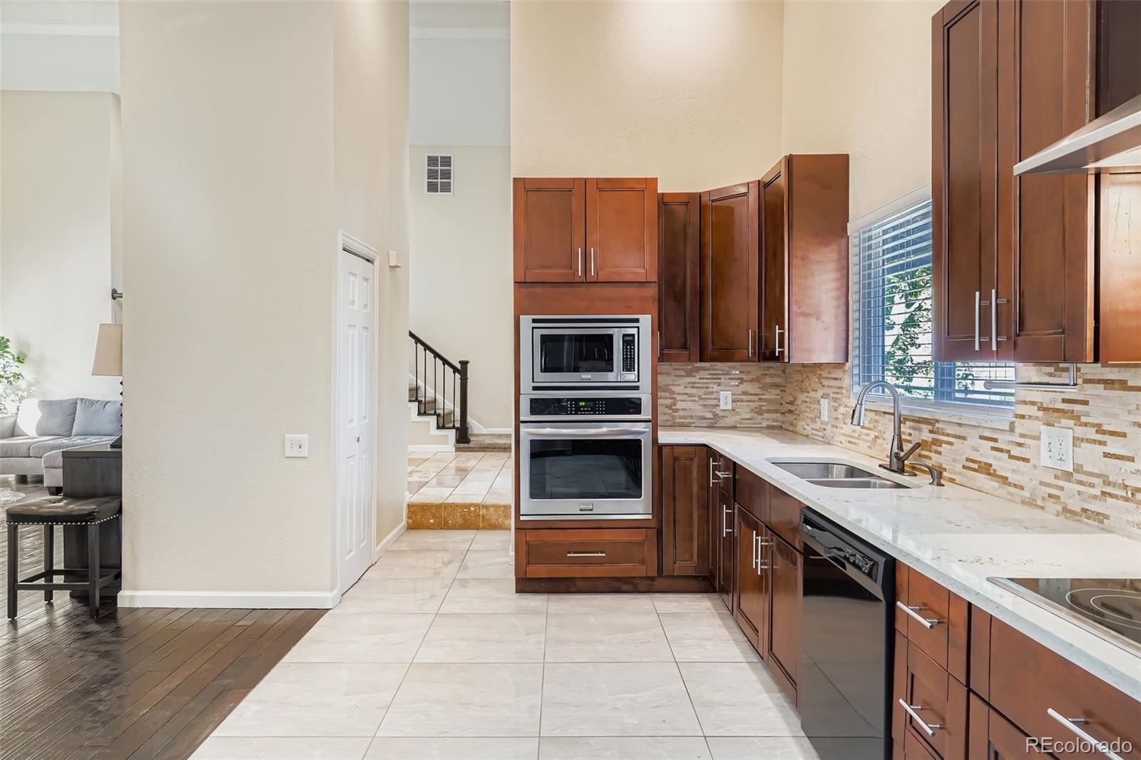 3301 South Magnolia Street Denver, CO 80224 - Photo 18 of 33 a kitchen with stainless steel appliances granite countertop a stove and a refrigerator