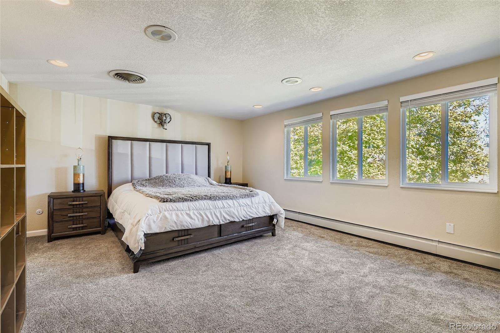 3301 South Magnolia Street Denver, CO 80224 - Photo 19 of 33 a bed sitting in a spacious bedroom next to a window