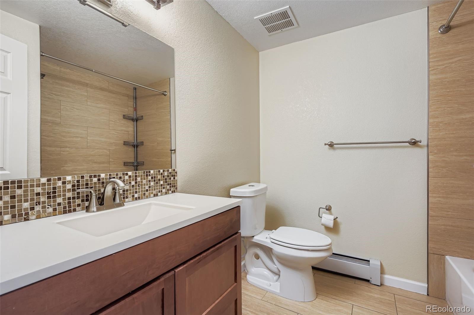 3301 South Magnolia Street Denver, CO 80224 - Photo 20 of 33 a bathroom with a sink a toilet and shower