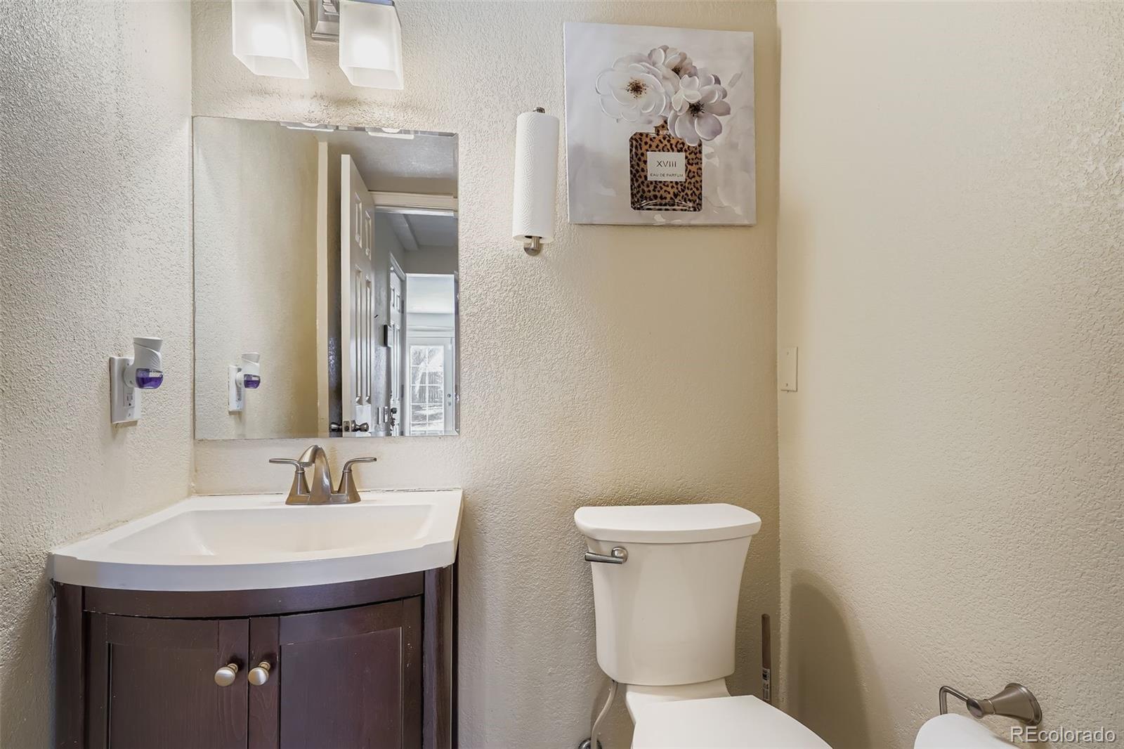 3301 South Magnolia Street Denver, CO 80224 - Photo 23 of 33 a bathroom with a toilet sink and mirror