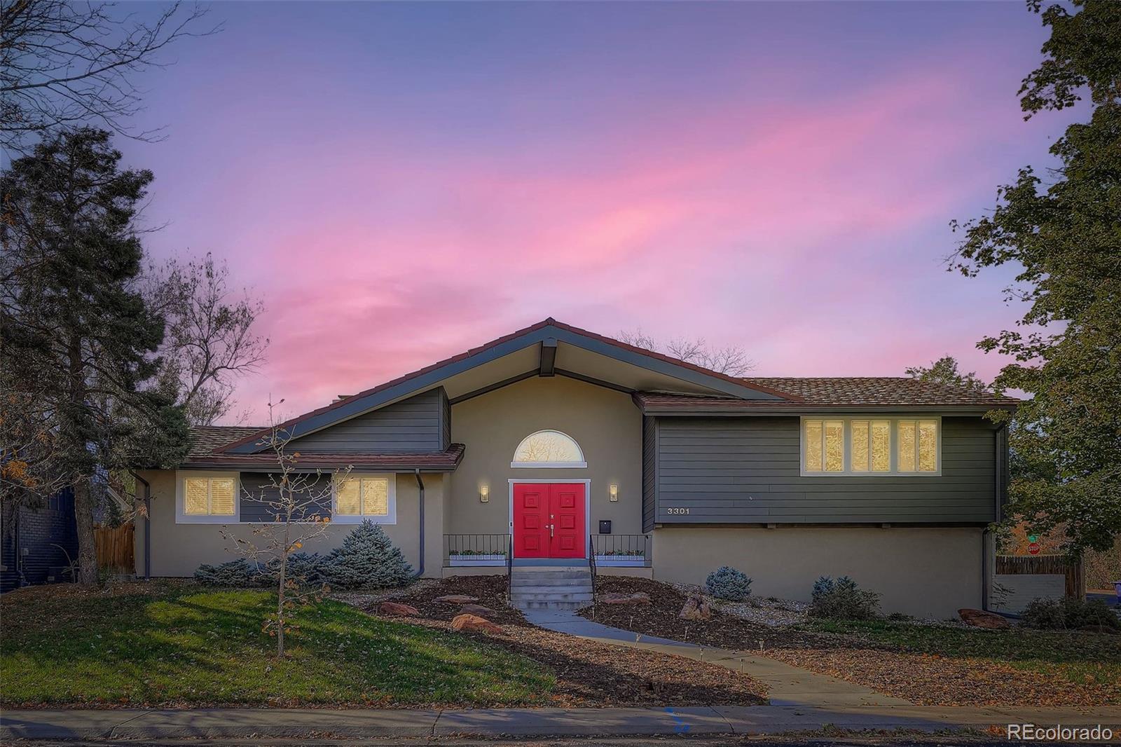 3301 South Magnolia Street Denver, CO 80224 - Photo 27 of 33 a front view of a house with a yard and garage