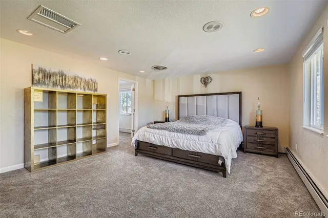 a spacious bedroom with a bed and a window
