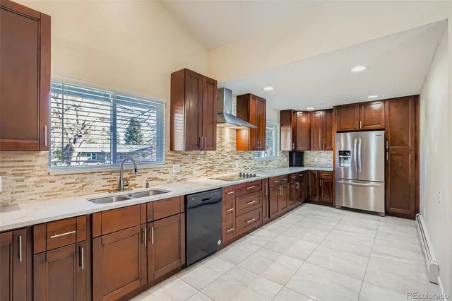 a kitchen with stainless steel appliances granite countertop a refrigerator and a sink