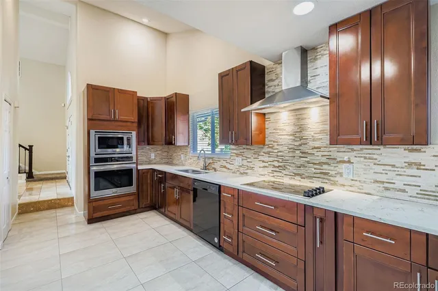 a kitchen with stainless steel appliances granite countertop a stove and a refrigerator