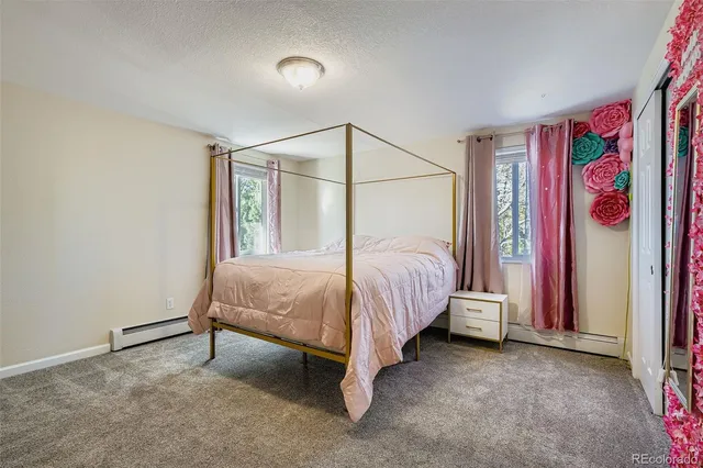 a bed room with a bed and a painting