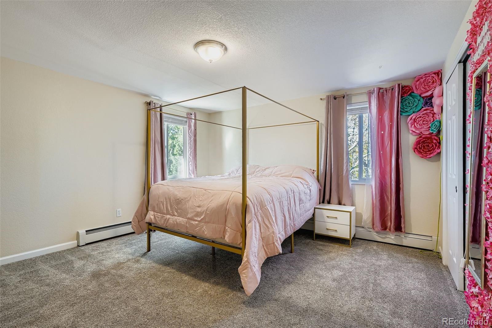 3301 South Magnolia Street Denver, CO 80224 - Photo 9 of 33 a bed room with a bed and a painting