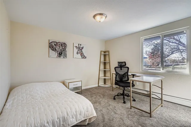 a bedroom with a bed and a desk