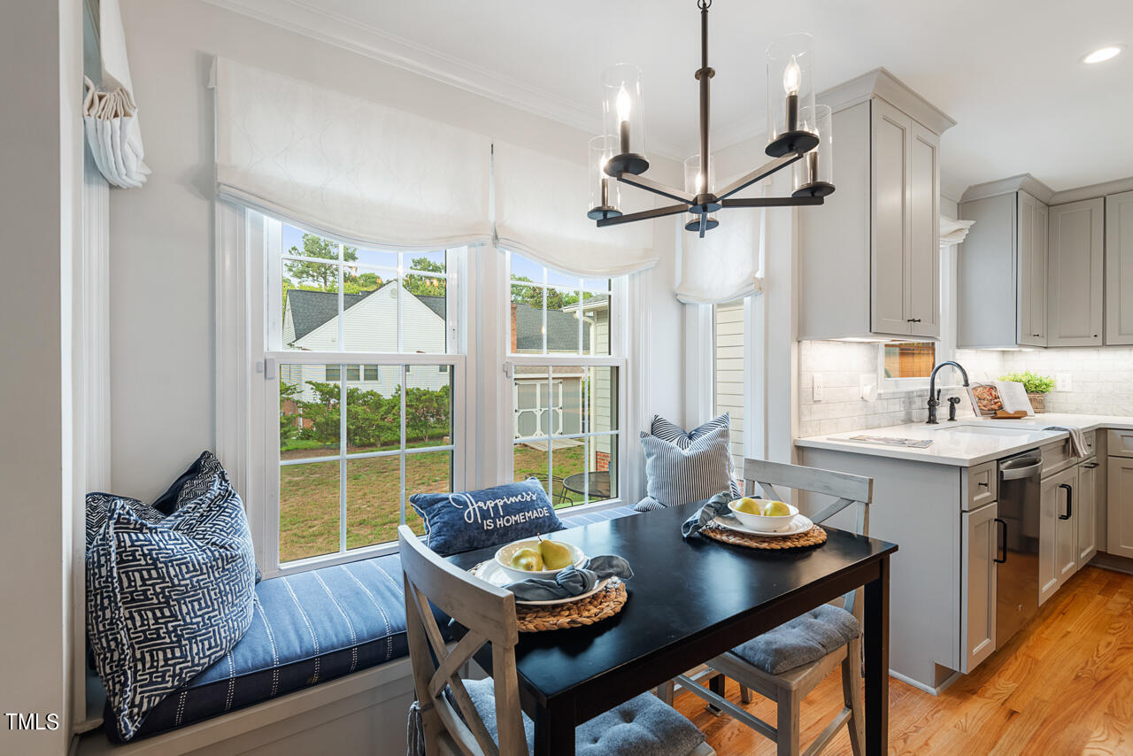 5 Caspian Court Durham, NC 27713 - Photo 12 of 48 a view of a dining room and livingroom with furniture wooden floor a chandelier