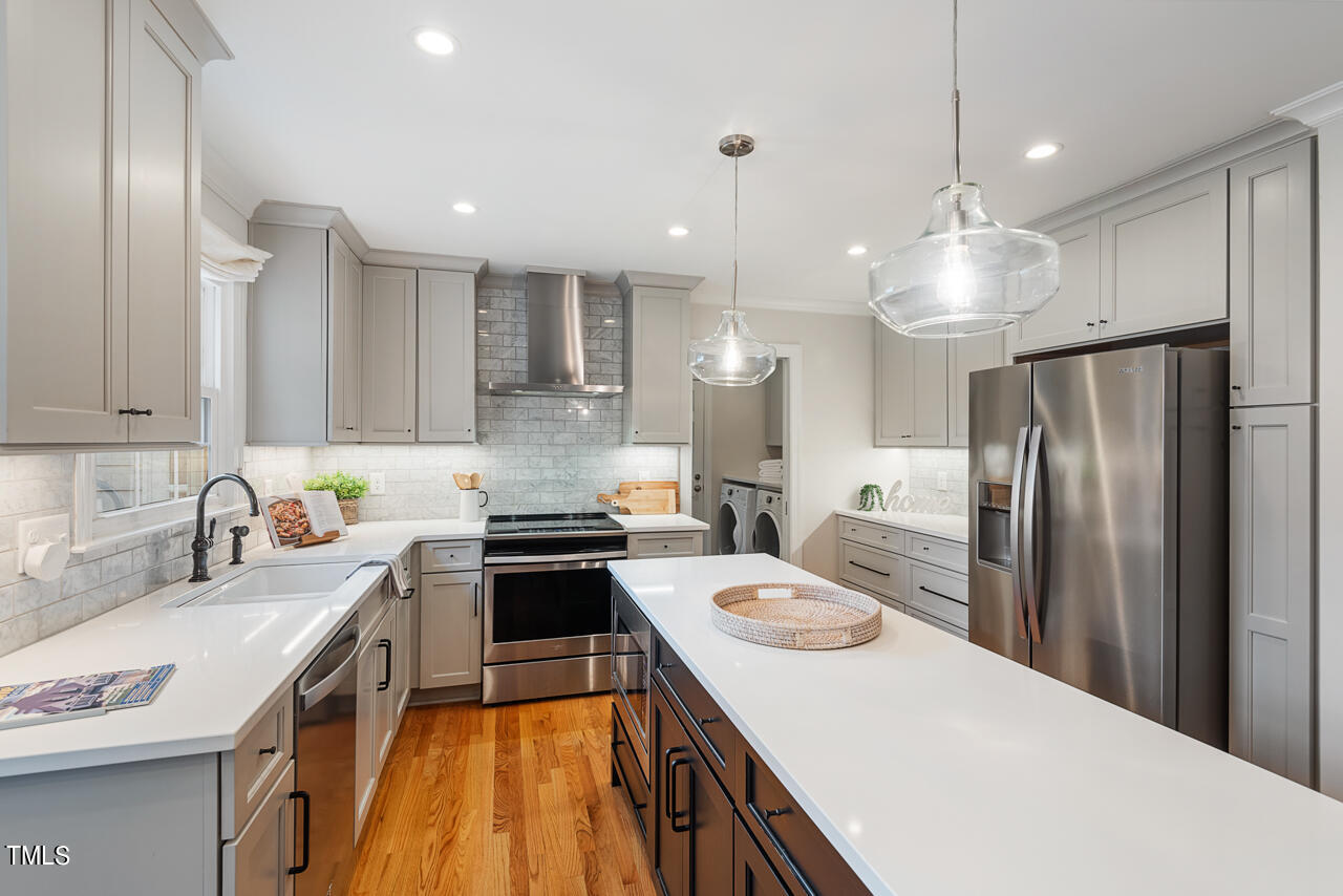 5 Caspian Court Durham, NC 27713 - Photo 15 of 48 a kitchen with a sink a stove a refrigerator and chairs