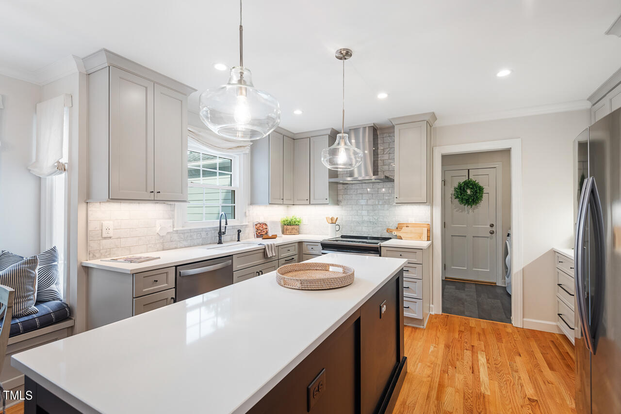 5 Caspian Court Durham, NC 27713 - Photo 18 of 48 a kitchen with a refrigerator a sink and wooden floor