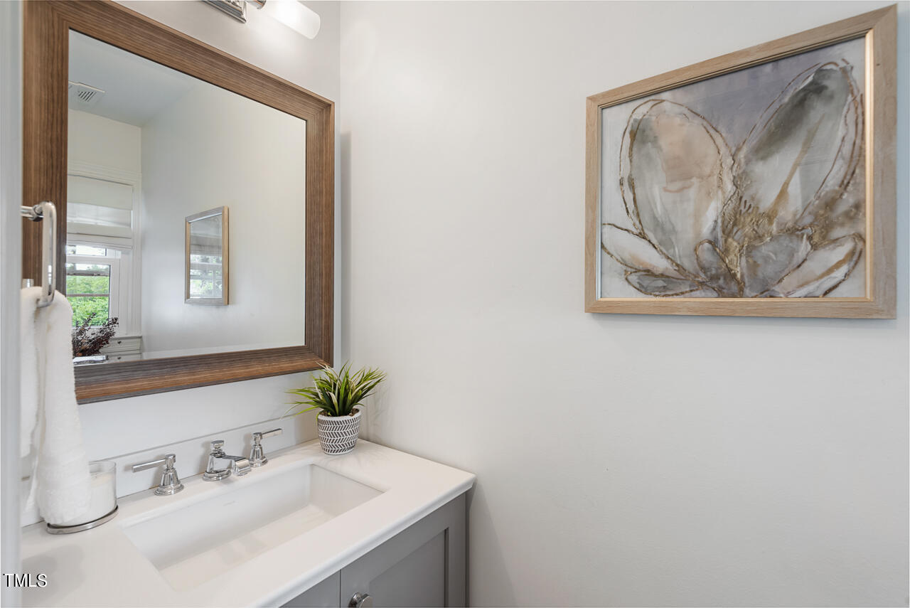 5 Caspian Court Durham, NC 27713 - Photo 25 of 48 a bathroom with a sink and a mirror