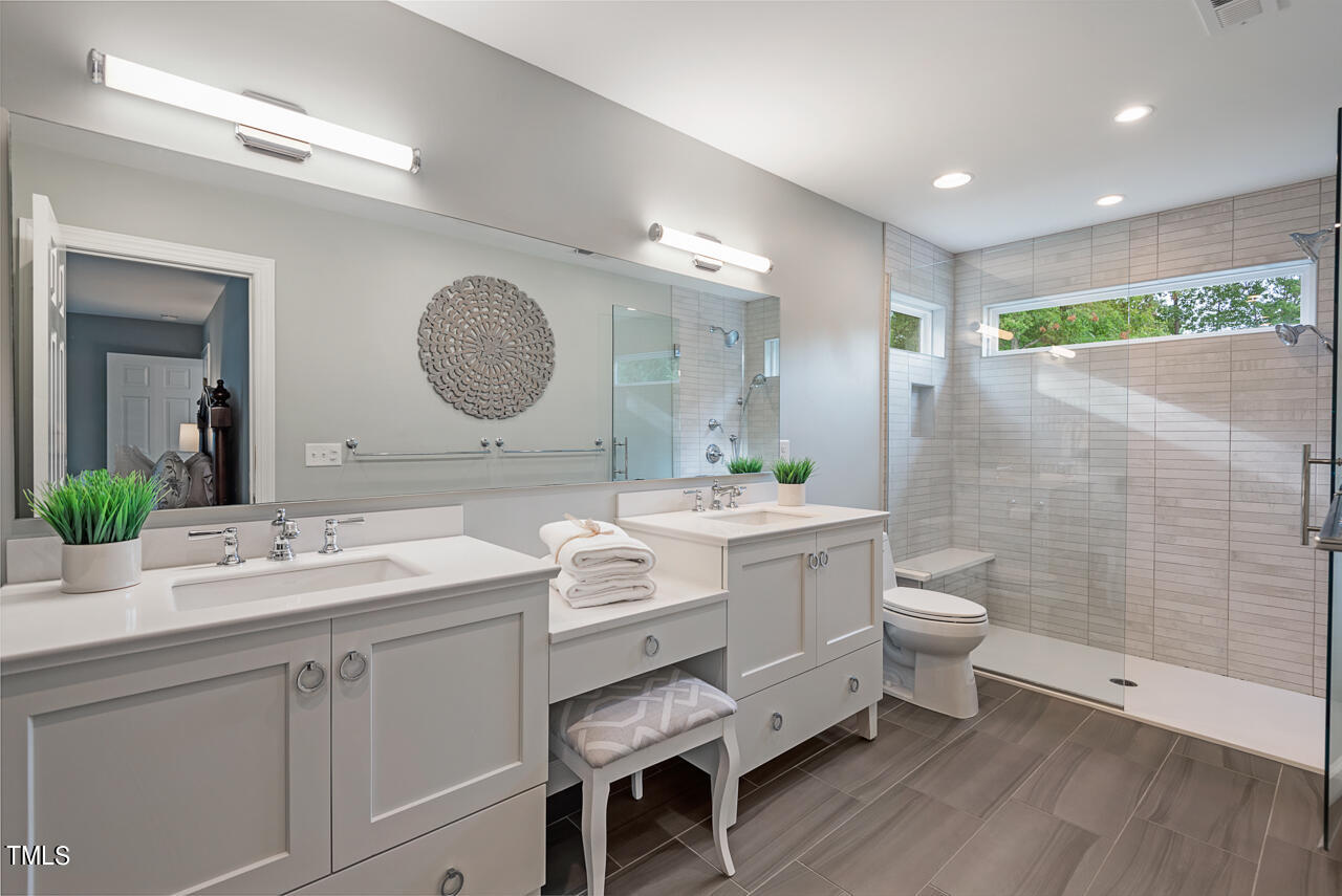 5 Caspian Court Durham, NC 27713 - Photo 30 of 48 a bathroom with a double vanity sink mirror and toilet