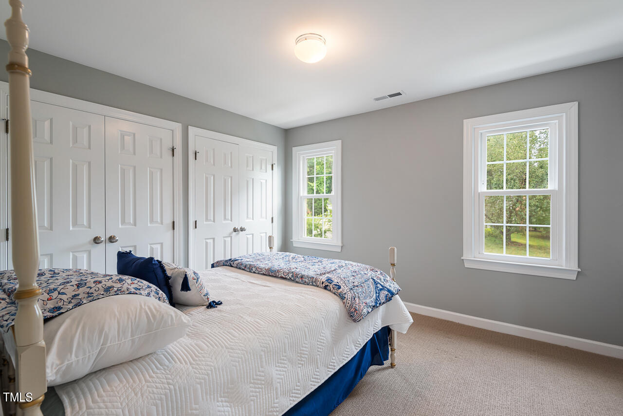 5 Caspian Court Durham, NC 27713 - Photo 32 of 48 a bedroom with a bed and a window