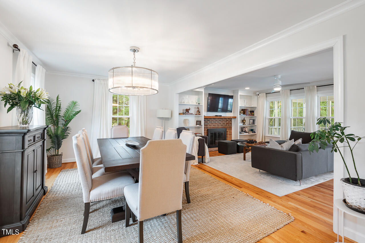 5 Caspian Court Durham, NC 27713 - Photo 5 of 48 a living room with furniture a chandelier a large window and a fireplace