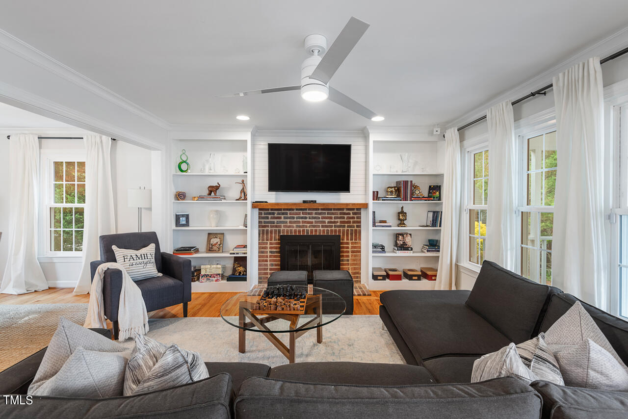 5 Caspian Court Durham, NC 27713 - Photo 9 of 48 a living room with furniture a fireplace and a flat screen tv