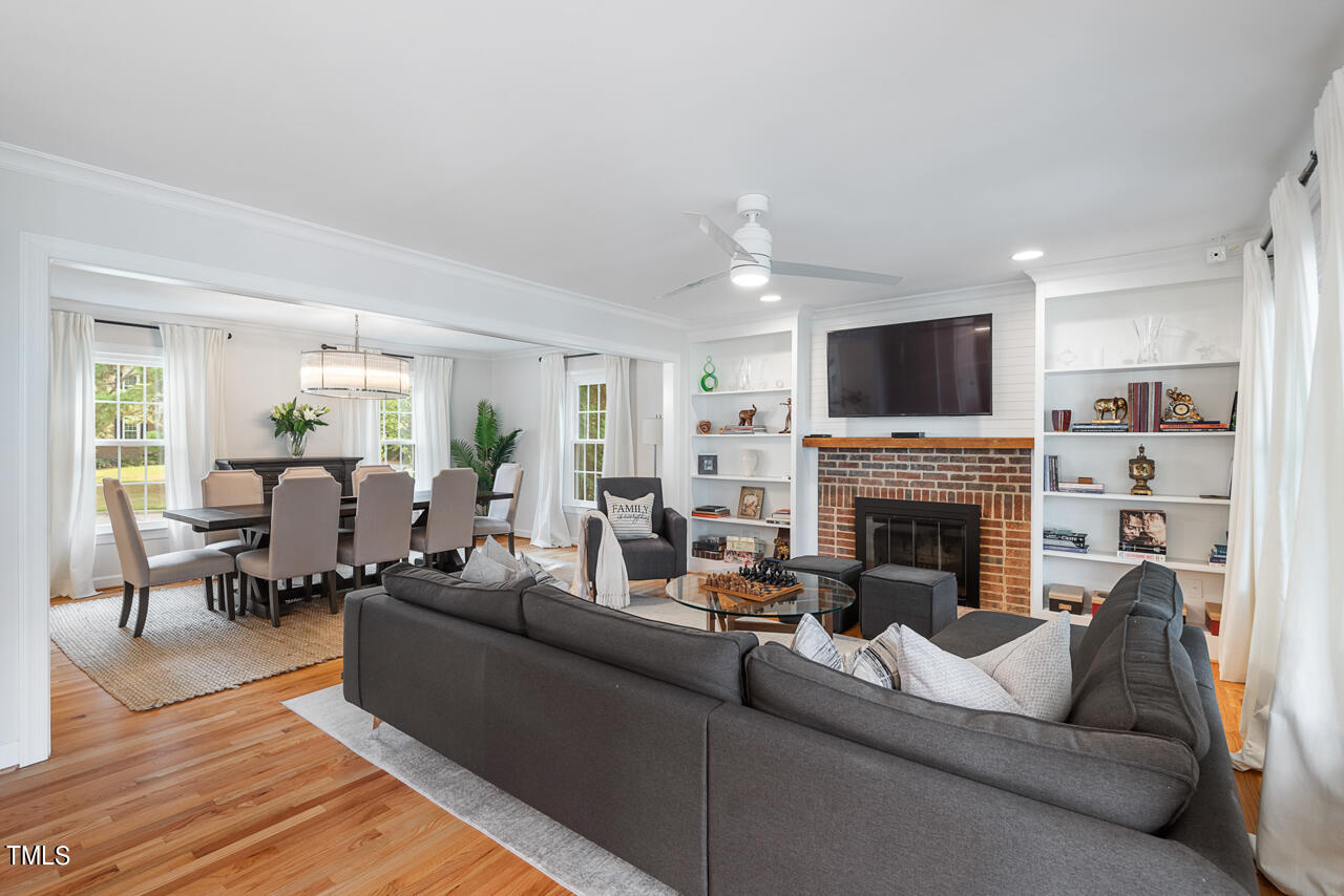 5 Caspian Court Durham, NC 27713 - Photo 10 of 48 a living room with furniture a fireplace and a flat screen tv