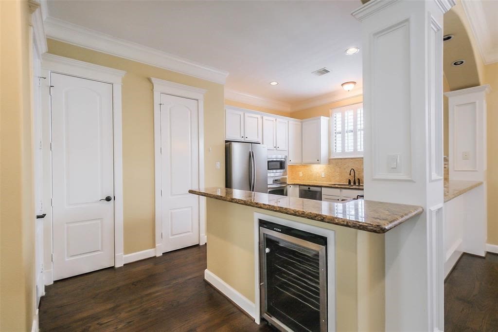706 Allston Street, Unit B Houston, TX 77007 - Photo 4 of 33 a kitchen with stainless steel appliances granite countertop a stove and a refrigerator