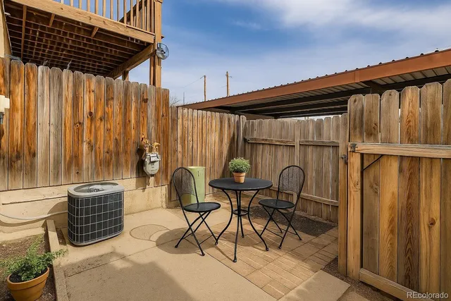 a patio with table and chairs