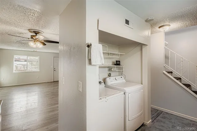 a view of a hallway with workspace and wooden floor