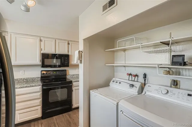 a kitchen with a microwave and a stove top oven