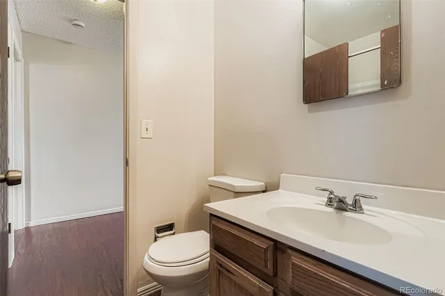 a bathroom with a sink toilet and a mirror