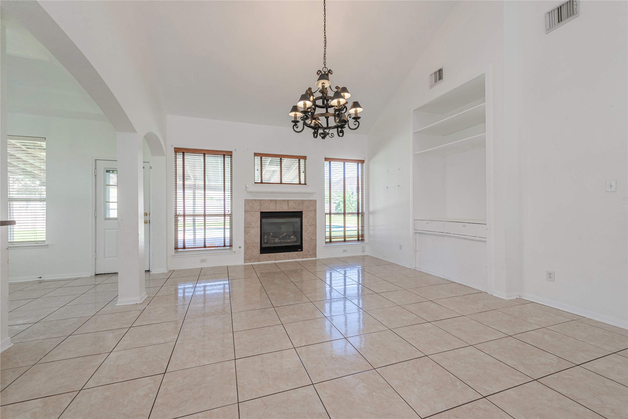 9518 Stone Terrace Court Houston, TX 77089 - Photo 12 of 27 a view of an empty room with a fireplace and a window