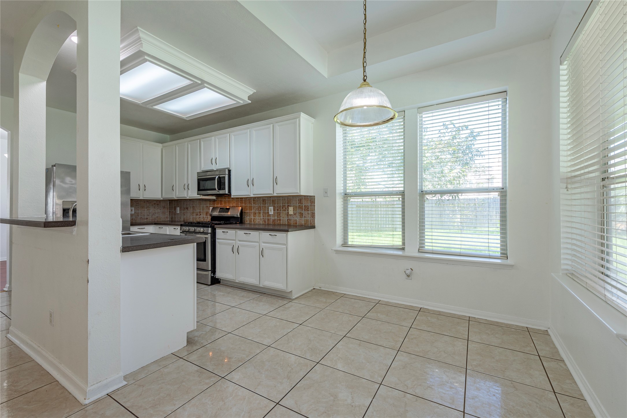 9518 Stone Terrace Court Houston, TX 77089 - Photo 15 of 27 a kitchen with stainless steel appliances granite countertop a stove top oven a refrigerator a sink and a window