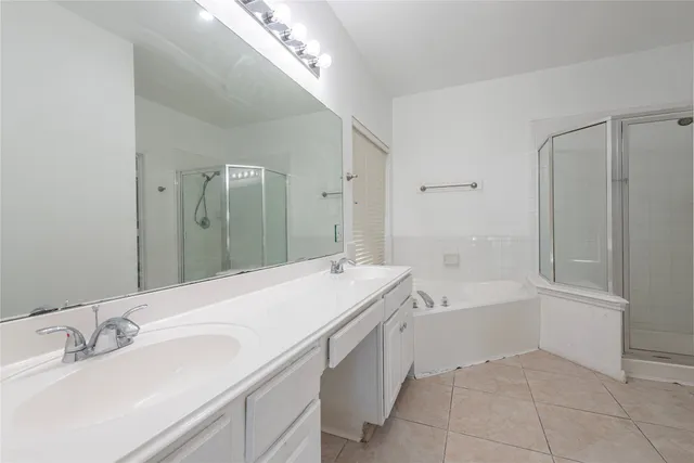 a bathroom with a tub sink and mirror