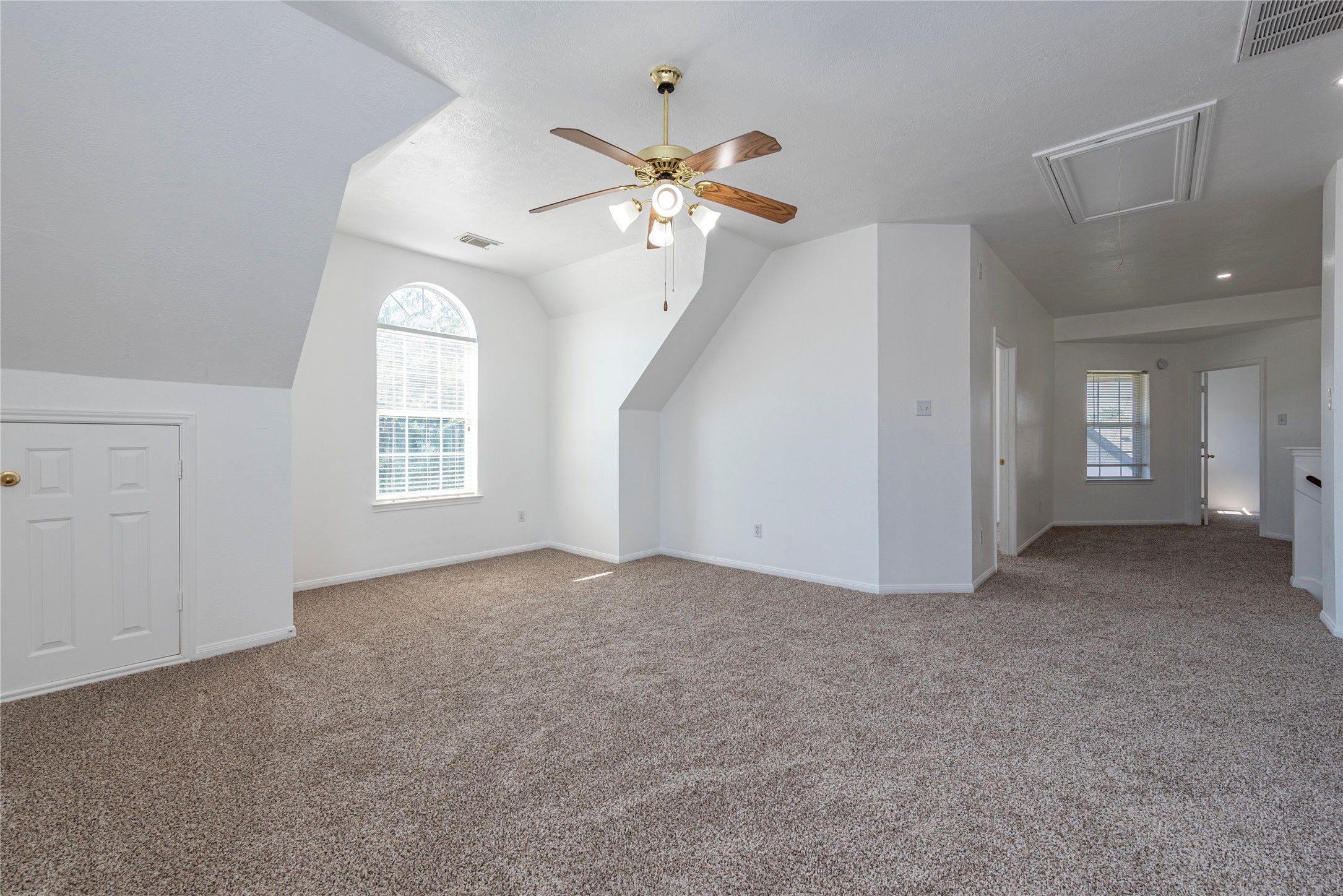 9518 Stone Terrace Court Houston, TX 77089 - Photo 22 of 27 an empty room with windows and fan