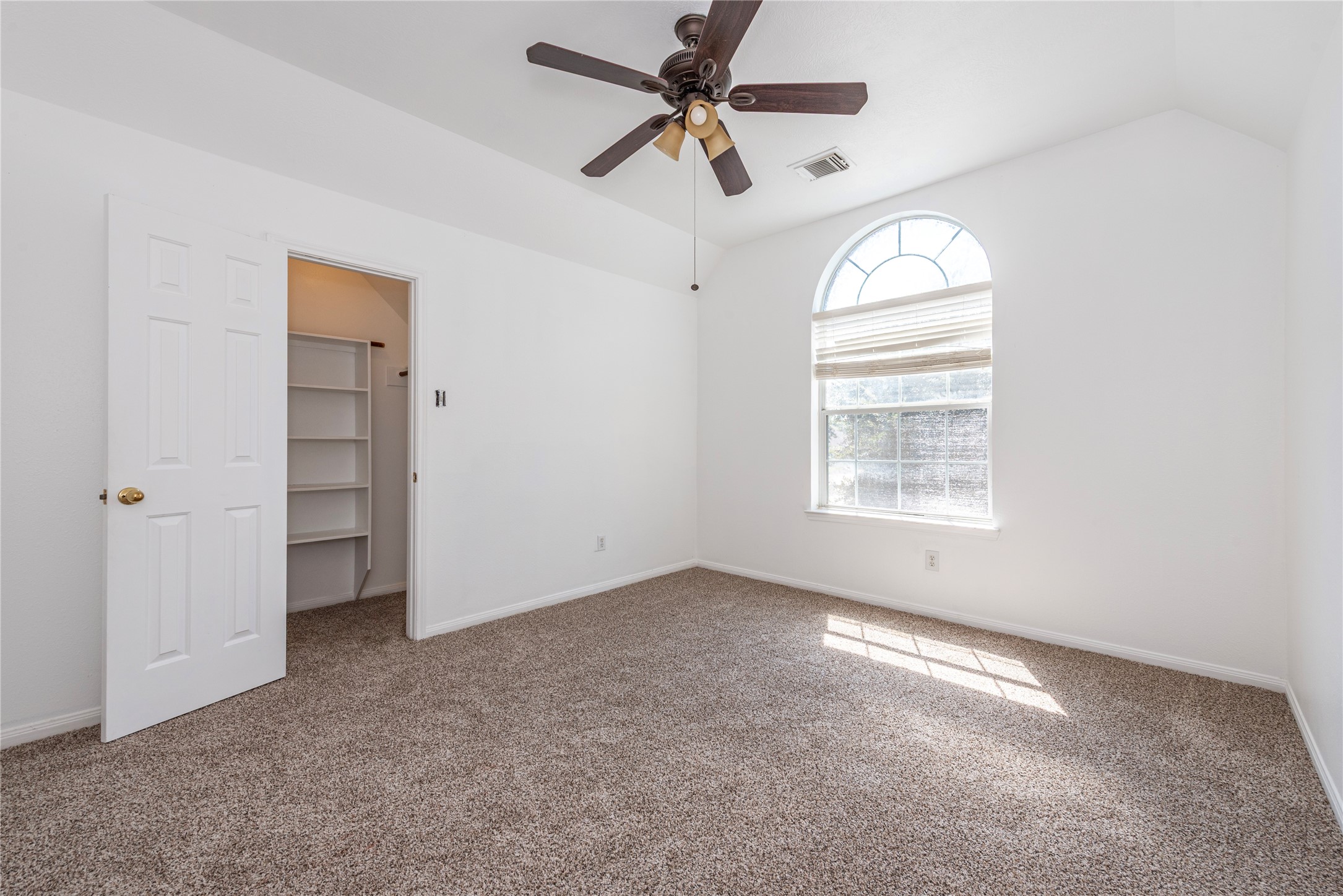9518 Stone Terrace Court Houston, TX 77089 - Photo 23 of 27 an empty room with windows and fan