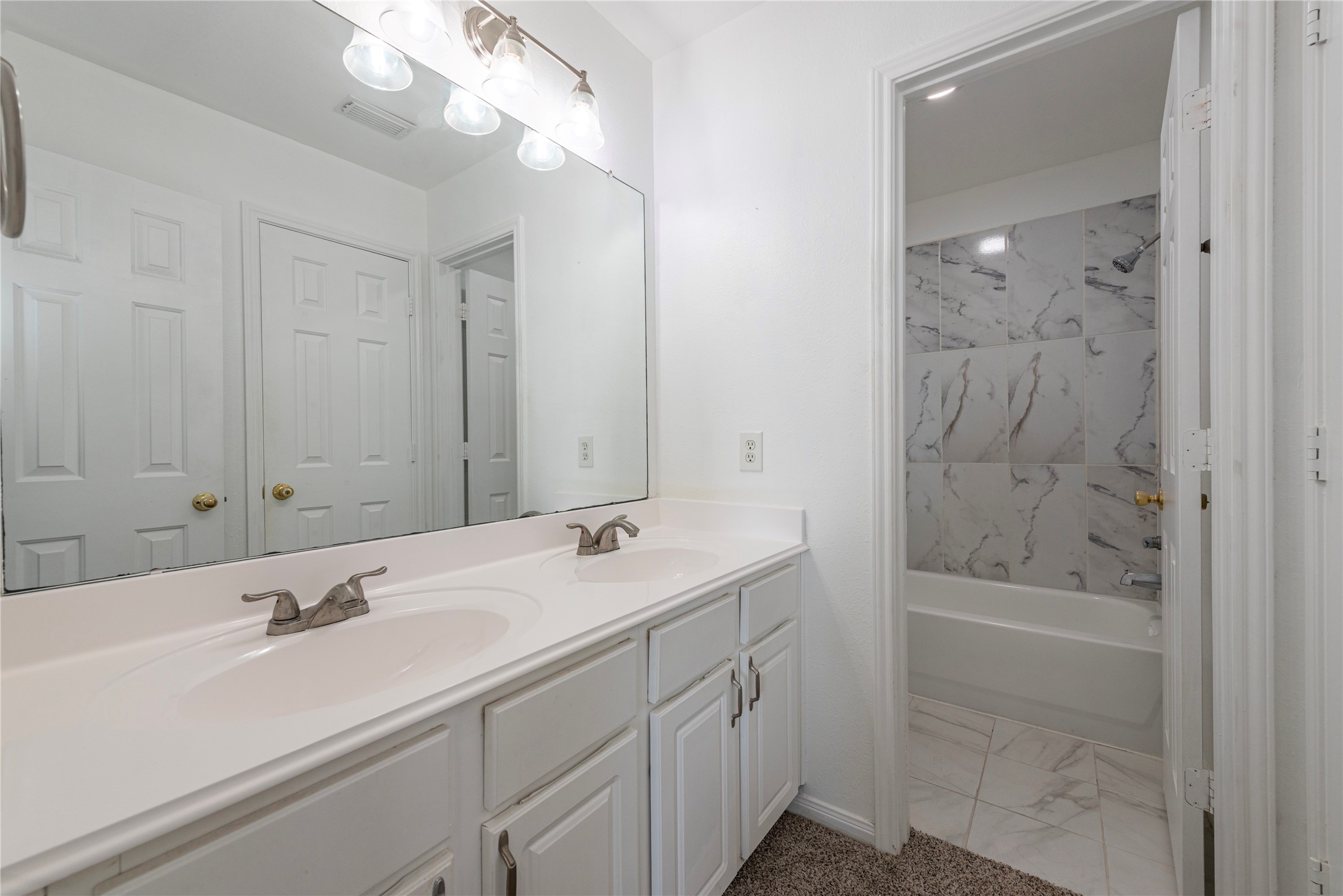 9518 Stone Terrace Court Houston, TX 77089 - Photo 26 of 27 a bathroom with a sink a shower and a mirror
