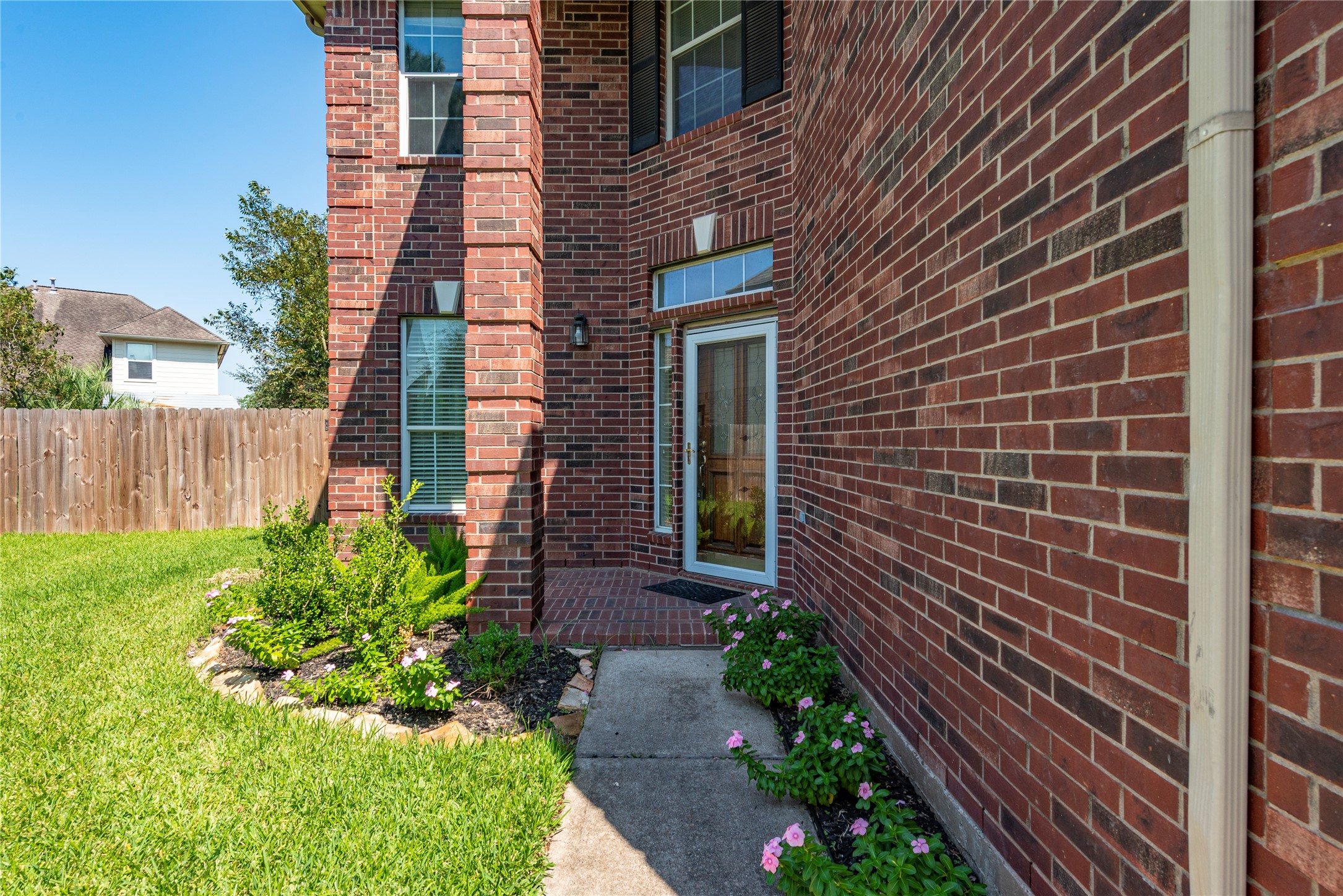 9518 Stone Terrace Court Houston, TX 77089 - Photo 3 of 27 a view of a brick house with a yard and wooden fence