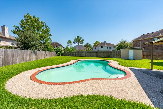 a view of a swimming pool with a yard