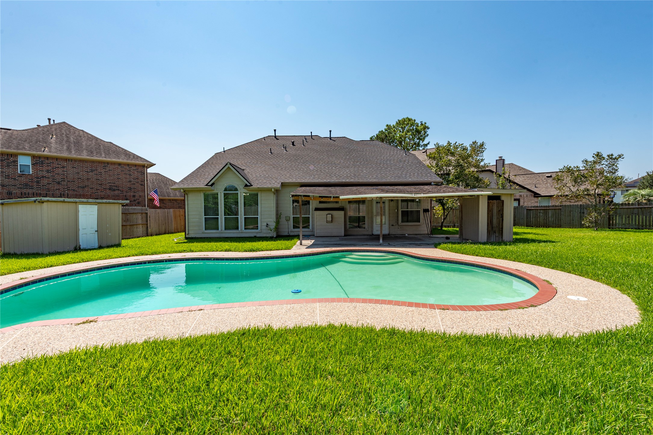 9518 Stone Terrace Court Houston, TX 77089 - Photo 7 of 27 a view of pool with a big yard and large trees