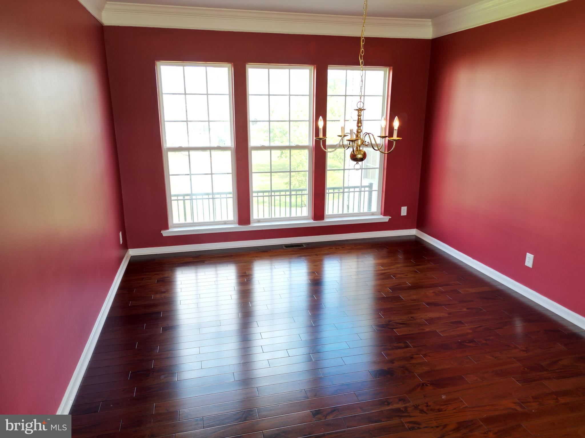107 Newgate Circle Smyrna, DE 19977 - Photo 11 of 45 a view of empty room with wooden floor and fan