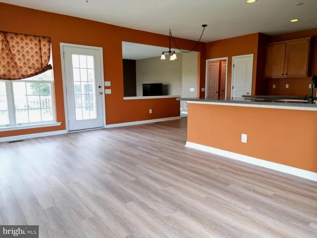 a view of a kitchen with a sink and a large window