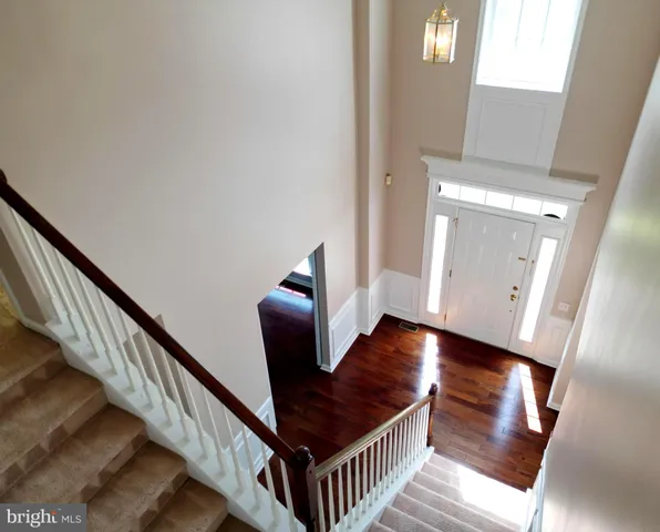 a view of an entryway with wooden floor and stairs