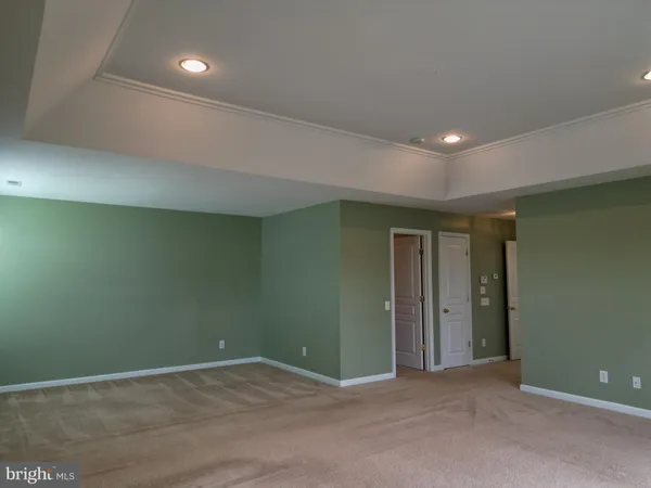 an empty room with wooden floor and closet area