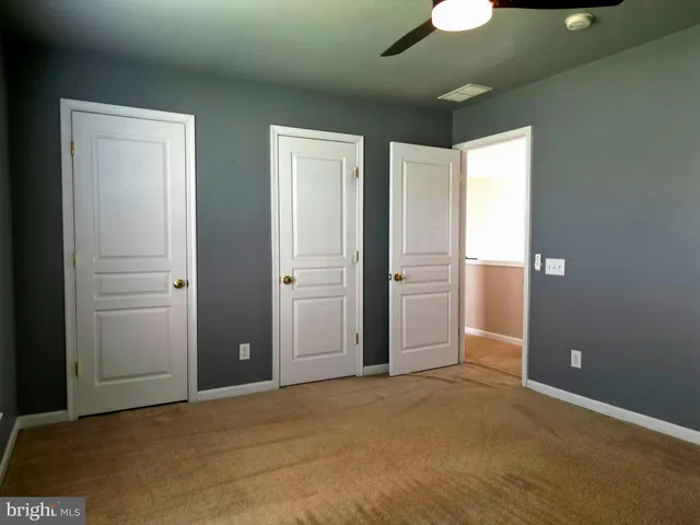an empty room with closet area