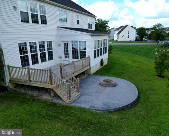 a view of a house with backyard and a garden
