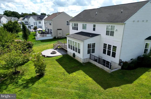 a aerial view of a house with a yard and sitting area