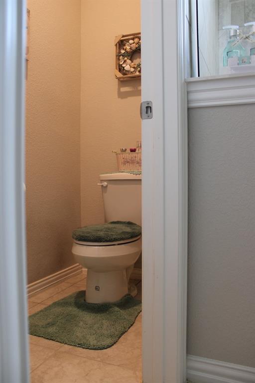 2267 County Road 4010 Decatur, TX 76234 - Photo 17 of 36 a bathroom with a toilet