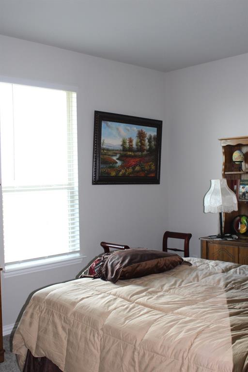 2267 County Road 4010 Decatur, TX 76234 - Photo 20 of 36 a bedroom with a bed and a window