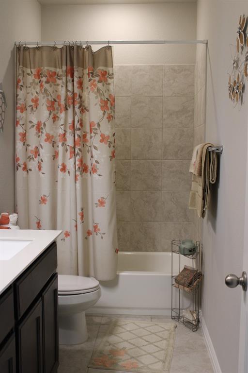 2267 County Road 4010 Decatur, TX 76234 - Photo 22 of 36 a bathroom with a sink a toilet and shower