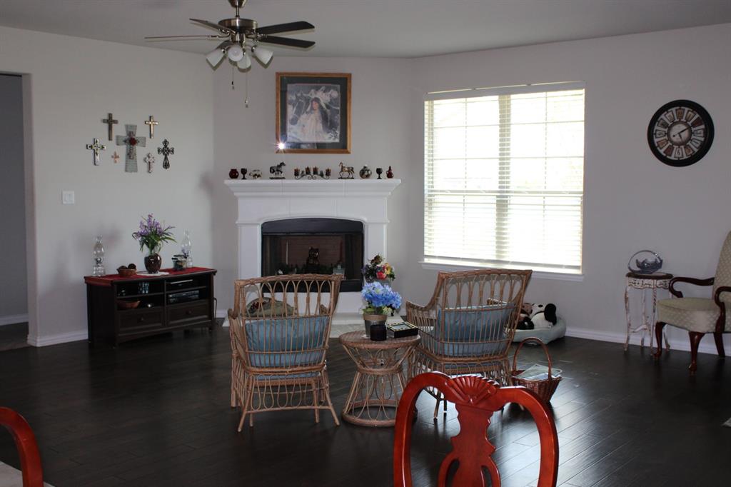 2267 County Road 4010 Decatur, TX 76234 - Photo 10 of 36 a living room with furniture a fireplace and a window