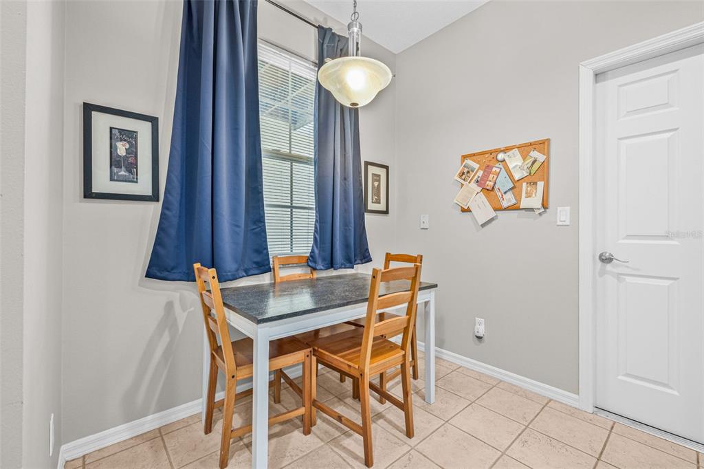 1050 Starkey Road, Unit 604 Largo, FL 33771 - Photo 13 of 28 a dining room with chandelier and wooden floor