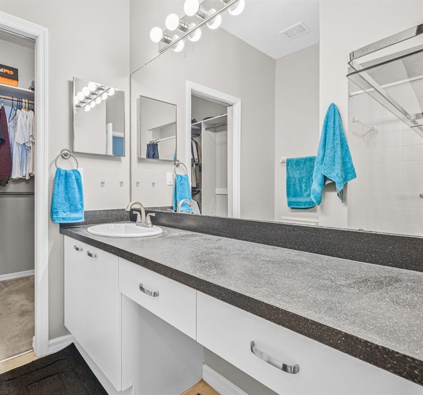 1050 Starkey Road, Unit 604 Largo, FL 33771 - Photo 17 of 28 a bathroom with a double vanity sink and a mirror