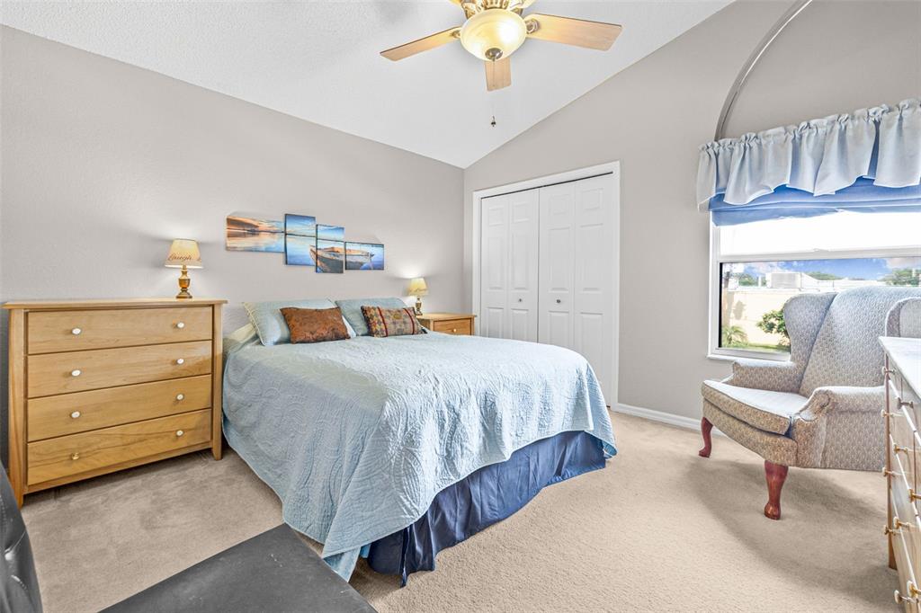 1050 Starkey Road, Unit 604 Largo, FL 33771 - Photo 22 of 28 a bedroom with a bed and a chandelier