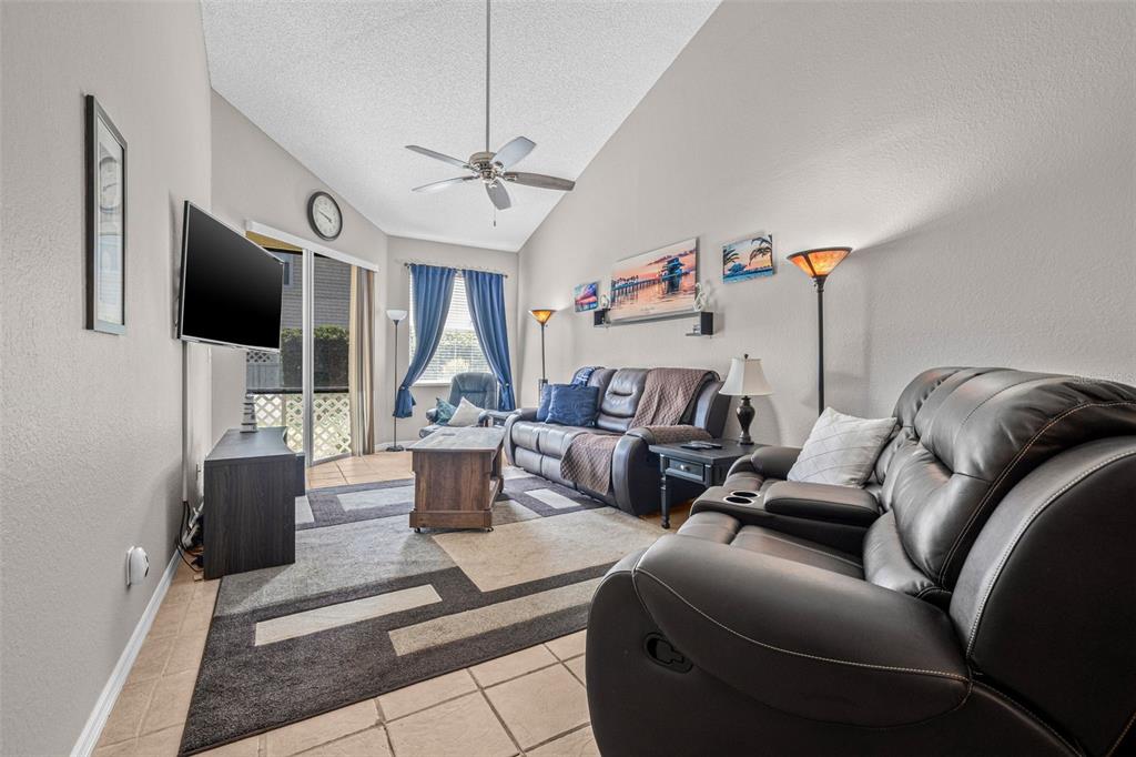 1050 Starkey Road, Unit 604 Largo, FL 33771 - Photo 6 of 28 a living room with furniture and a flat screen tv