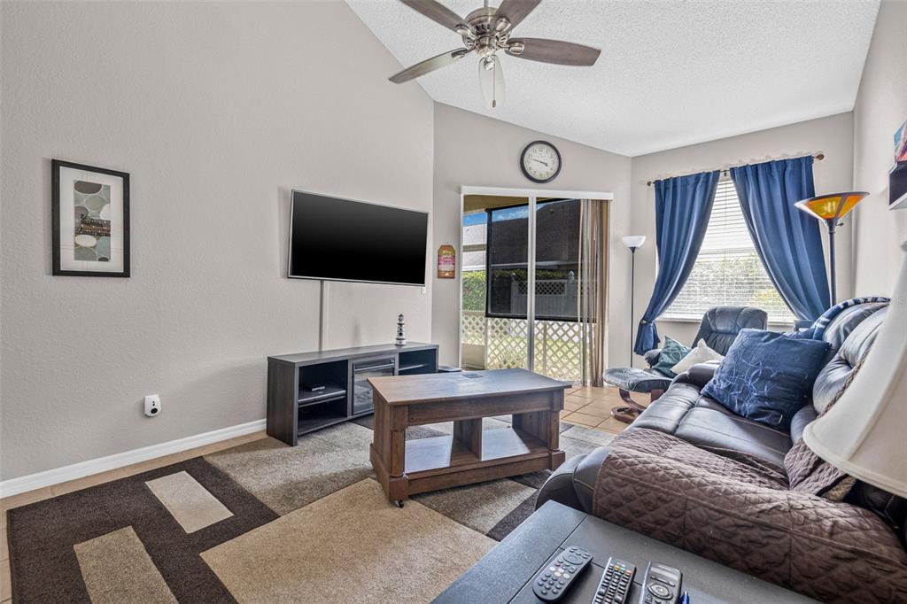 1050 Starkey Road, Unit 604 Largo, FL 33771 - Photo 7 of 28 a living room with furniture and a flat screen tv